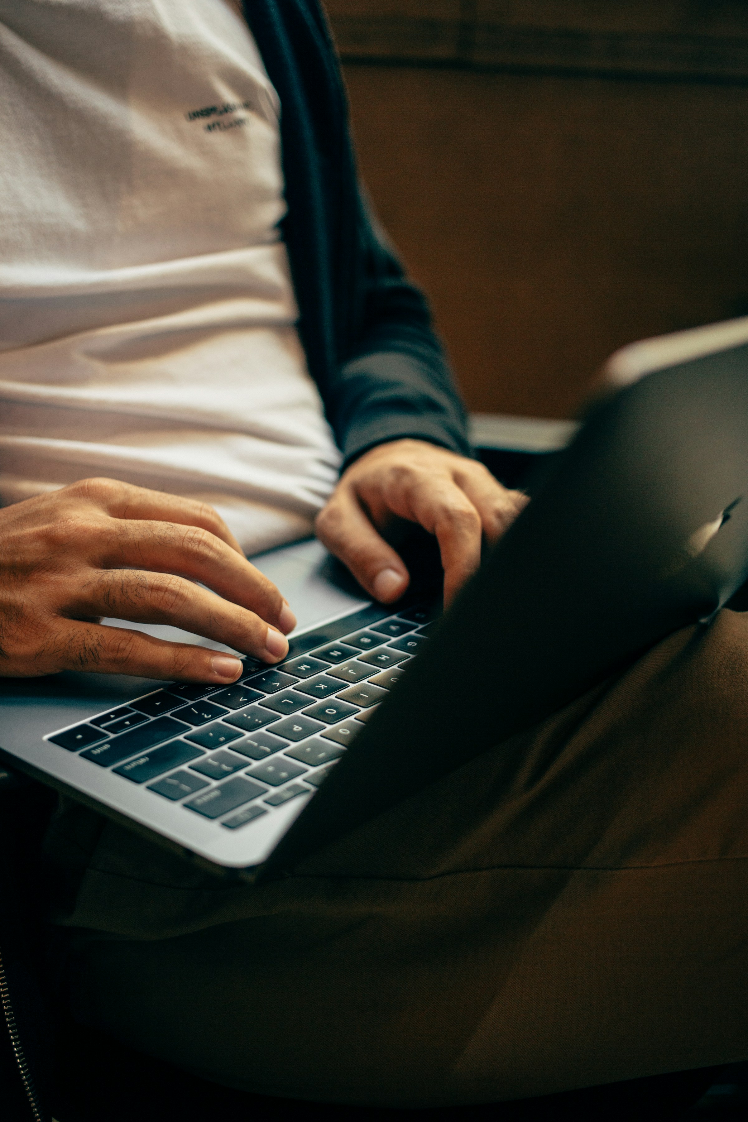 Hands typing on a laptop.